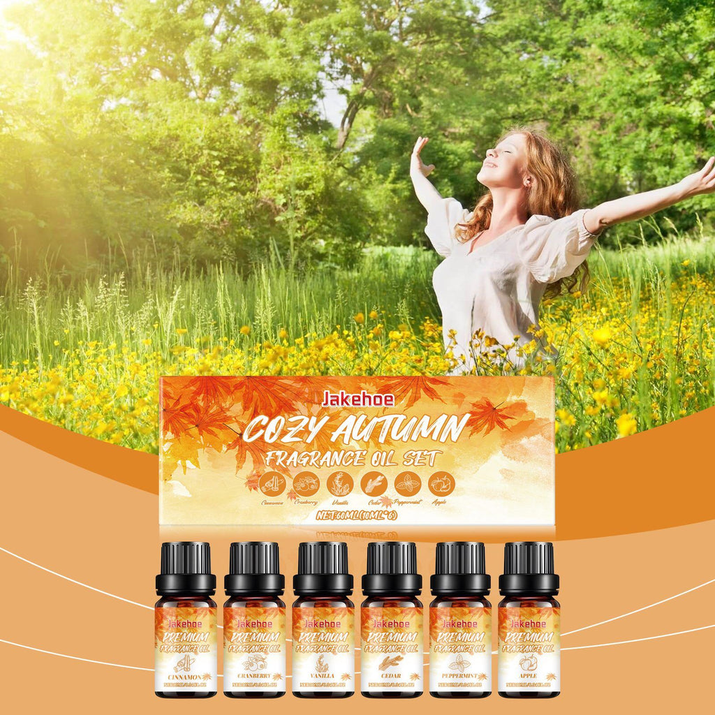 Autumn Hearth fragrance oil set shown with a summer meadow scene