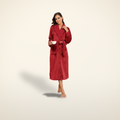 Firelight plush robe in wine red, shown worn, on a warm candlelight cream background