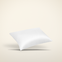 Pure mulberry silk pillowcase on a warm candlelight cream background