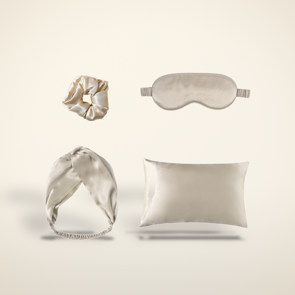 Silk Sunday Reset Set with scrunchie, eye mask, headband and pillowcase on a warm candlelight cream background